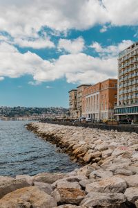 Kaboompics - Rocky Naples Waterfront With Seaside Hotels Beneath Cloudy Sky