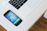 Kaboompics - White laptop with smartphone