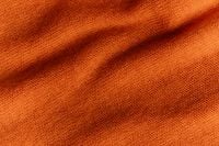 Kaboompics - Orange Knit Fabric Texture – Draped Sweater Background