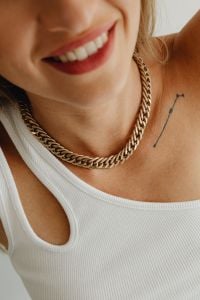 Kaboompics - Smiling Blonde Woman Wearing a Gold Chain Necklace and White Tank Top