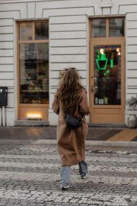 Kaboompics - Rear View of Woman Crossing the Street Toward a City Cafe