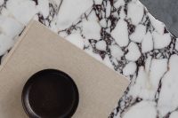 Kaboompics - Close-Up of Dark Ceramic Bowl on Linen Book and Marble