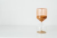 Kaboompics - Amber Sand Hourglass on the Right of a White Surface with Wide Left Copy Space