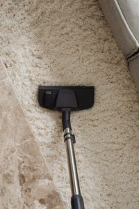 Kaboompics - Vacuum Cleaner Head on a Rug Beside a Sofa