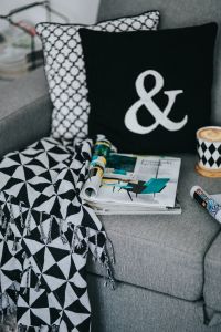 Kaboompics - Close-Up Coffee Break Scene with Magazines and Geometric Throw Blanket