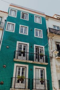 Kaboompics - Teal Azulejo-Tiled Lisbon Facade with White-Trimmed Windows and Balconies