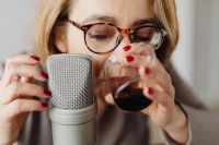 Kaboompics - Close Portrait of Woman with Wine Glass and Microphone for ASMR Sounds