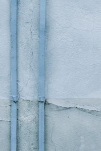 Kaboompics - Blue Wall with Pipes and Cracked Plaster