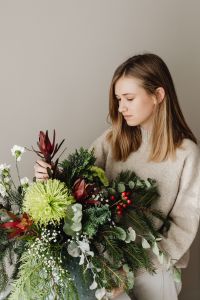 Kaboompics - Woman Arranging Holiday Greenery and Flowers