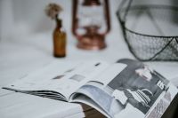 Kaboompics - Magazine with a paraffin lamp on a white table