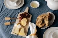 Kaboompics - Breakfast Table with Cheese Board Bread and Olive Oil