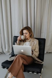 Kaboompics - Businesswoman Drinking Coffee beside Her Laptop
