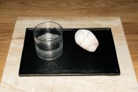 Kaboompics - Minimal Black Tray with Textured Drinking Glass and Pale Stone on Beige Marble Surface