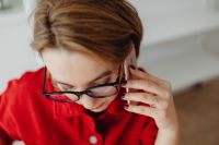 Kaboompics - Overhead Close-Up Woman Checking Phone with Eyeglasses at Desk