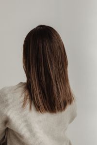 Kaboompics - Centered Back View of Smooth Brown Hair and Cream Knitwear