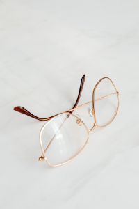 Kaboompics - Gold Wire Frame Glasses On White Marble Background