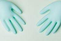 Kaboompics - Pair of Blue Disposable Nitrile Medical Gloves on a Pale Mint Background