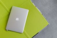 Kaboompics - Closed Laptop Resting on Lime Green Seating in a Business Lounge