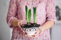 Kaboompics - Woman in pink holding a plant