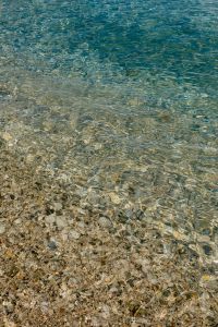 Kaboompics - Clear Turquoise Seawater and Pebble Shore with Natural Ripples