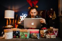 Kaboompics - Man Using Laptop in Cozy Christmas Gift Setting