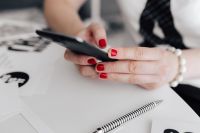 Kaboompics - Businesswoman uses her mobile phone at her desk