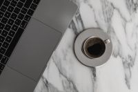 Kaboompics - Overhead Chrome Espresso Cup beside Laptop on Arabescato Marble, Minimal Remote Work Coffee Break
