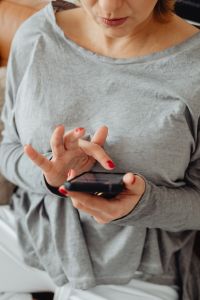 Kaboompics - Woman Using Phone With Bitcoin Coins