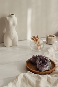 Kaboompics - White Torso Vase With Palm Leaf And Books
