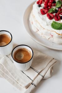 Kaboompics - Vertical Coffee and Berry Cake Still Life with White Linen and Copy Space