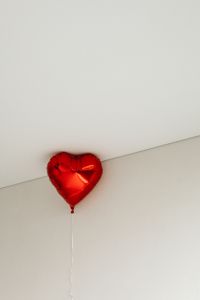 Kaboompics - Single Red Heart Balloon Floating in a Minimal Room