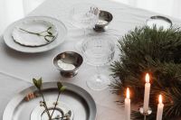 Kaboompics - White Christmas Table Setting with Lit Candles in Silver Candlestick and Linen Napkins