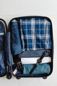 Kaboompics - Suitcase Organization with Folded Denim, Plaid Shirt and Travel Clothing