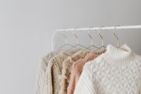 Kaboompics - Minimal Clothing Rack With Cream and Blush Sweaters