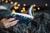 Kaboompics - Open Book Held in Both Hands During a Relaxed Home Reading Break