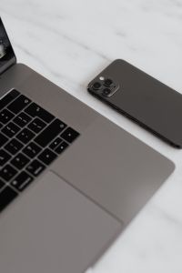 Kaboompics - MacBook Pro 15 laptop and iPhone 11 Pro on a marble table
