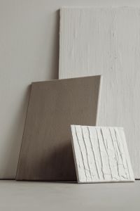 Kaboompics - Layered Neutral Paint Samples Leaning Against a Studio Wall