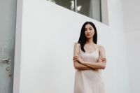Kaboompics - Asian Woman in Pale Dress against White Wall with Copy Space