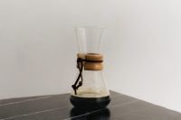 Kaboompics - Minimal Glass Chemex Coffee Brewer on Black Slate Table