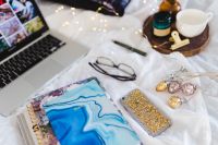 Kaboompics - Close-Up Of Blue Marble Diary On A Cozy Bed Workspace