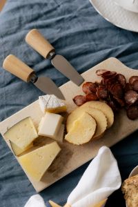 Kaboompics - Cheese Platter with Bread and Wooden Cheese Knives