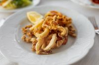 Kaboompics - Fried Calamari and Shrimp with Lemon on White Plate