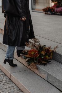 Kaboompics - Black Coat and Ankle Boots Beside an Autumn Bouquet on Steps
