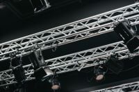 Kaboompics - Stage Lighting Rig with Black Spotlights Mounted on Silver Exhibition Trusses