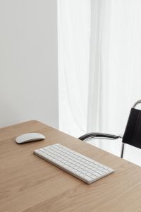 Kaboompics - Vertical Home Office Background with Oak Desk, Black Chair and Sheer Curtain Copy Space