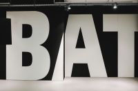 Kaboompics - Large White Exhibition Typography on a Black Wall, Contemporary Graphic Display