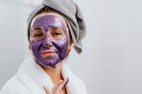 Kaboompics - Woman in a Gray Towel Wrap Posing with a Purple Face Mask During Home Skincare