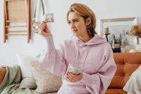 Kaboompics - Woman counts money - dollars - currency - bill