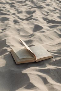Kaboompics - Beach Reading with an Open Book and Wind-Lifted Page