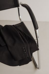 Kaboompics - Black Blazer Draped over Chrome Chair
